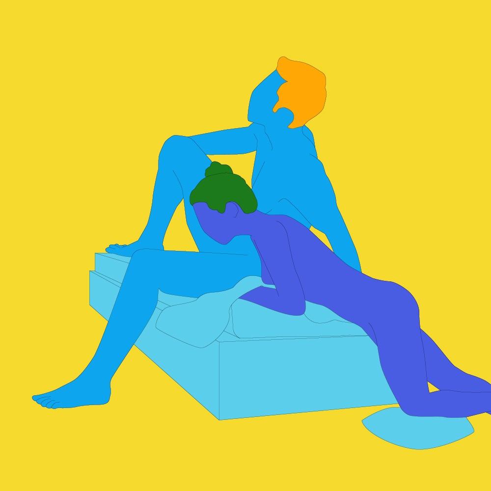 A naked illustrated couple in a seated position. One is sat on a sofa, leaning back with legs open and the other is knelt next to them.